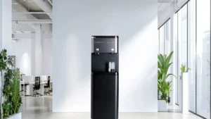 Modern water cooler in a bright, spacious office setting with plants.