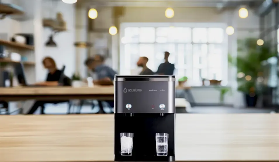 Water cooler with two glasses on a modern office table.